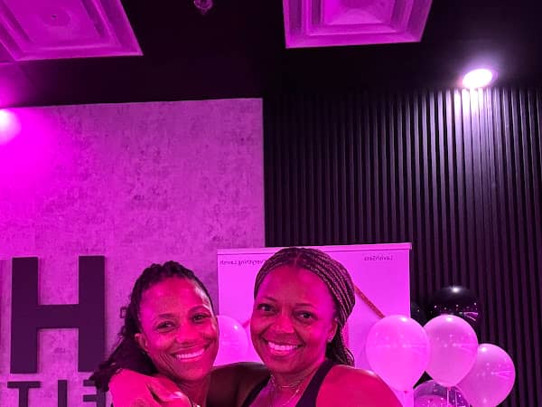 Two members smiling at a HILI Fitness Lake Nona pilates event