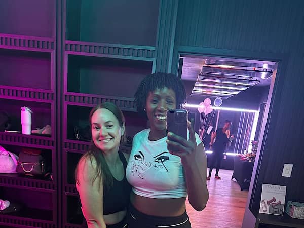 Two members taking a mirror selfie at HILI Fitness Lake Nona pilates studio