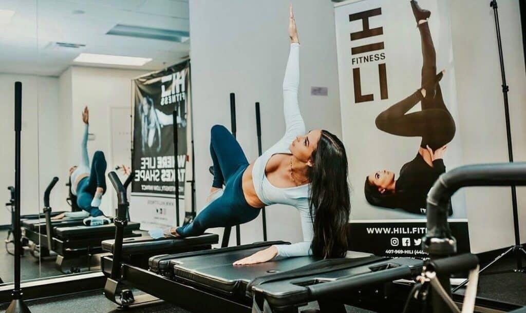 Members working on XFormer pilates machines at HILI Fitness Lake Nona on Narcoossee Road