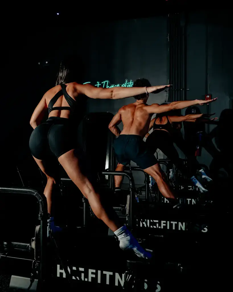 Man and woman holding a lunge on XFormer pilates machines at HILI Fitness
